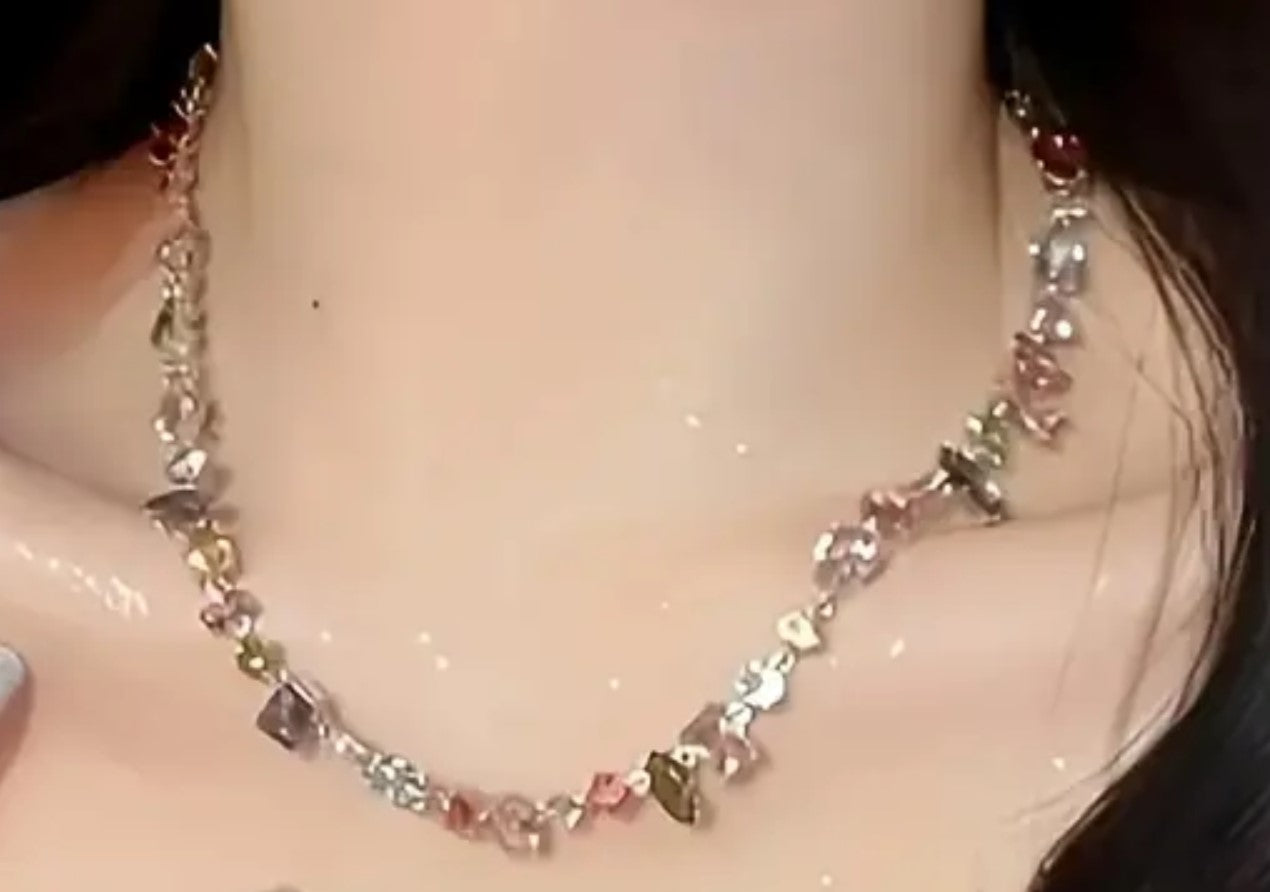 Woman wearing vibrant rainbow zircon crystal fancy necklace, showing dazzling style in Pakistan