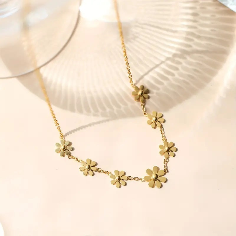 Side view of 18K gold plated sunflower daisy pendant necklace, showing delicate chain