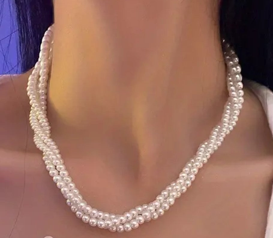 Woman wearing elegant multi strand chunky pearl statement necklace, party wear style in Pakistan.