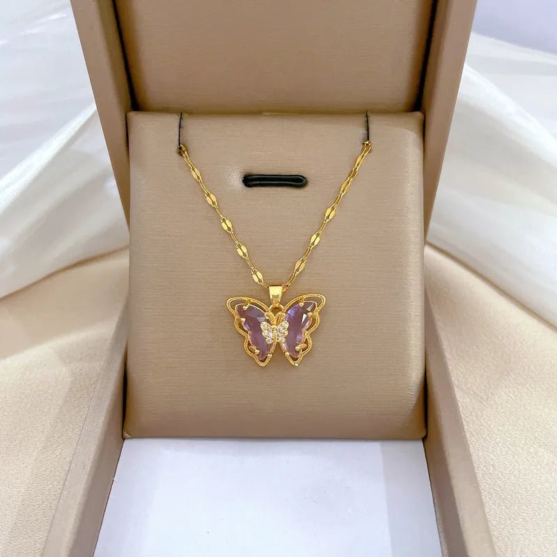Close up of sparkling cubic zircon butterfly pendant on 18K gold plated lip chain necklace