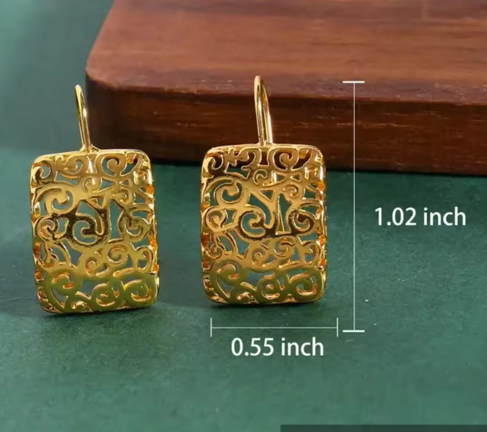 Back view of 14K gold plated hollow filigree drop earrings, showing craftsmanship