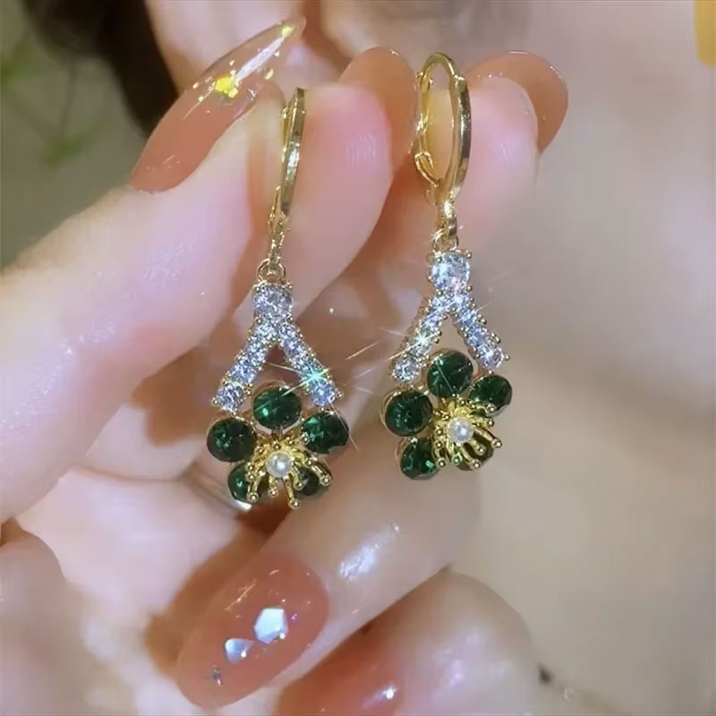 Close up of sparkling green and white zircon crystals on dangle earrings