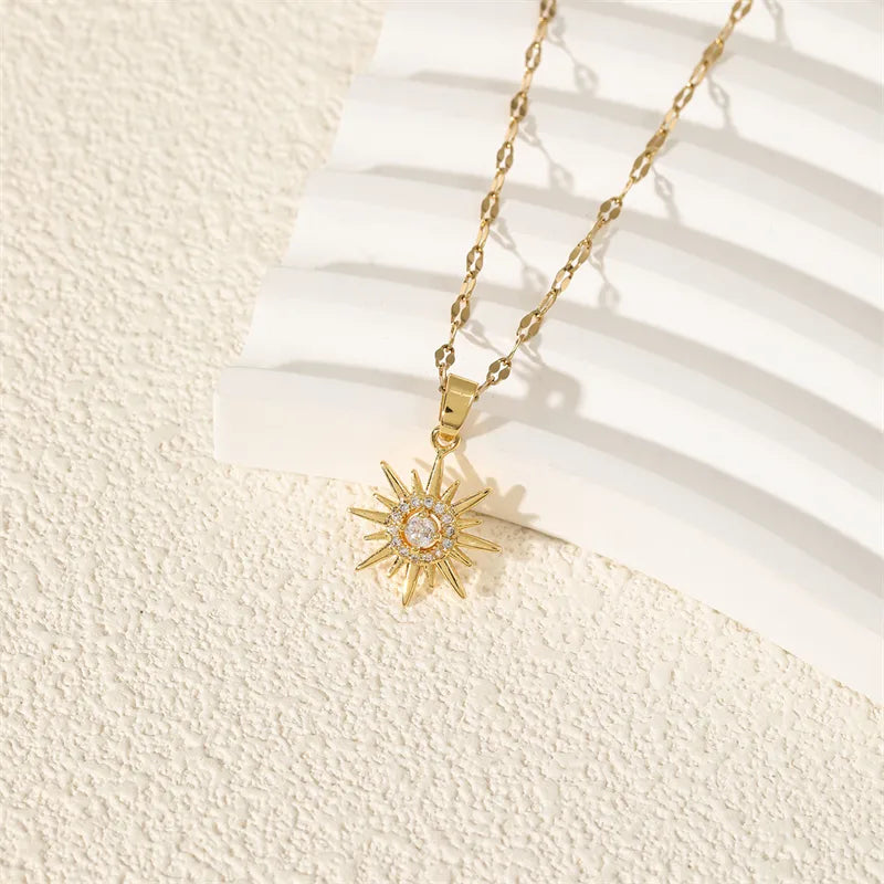 Close up of intricate sun charm with rhinestone decor on necklace