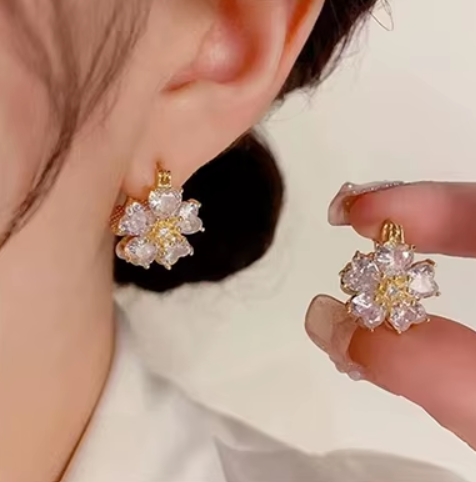 Close up of lustrous simulated pearls and sparkling cubic zirconia on elegant flower hoop earrings