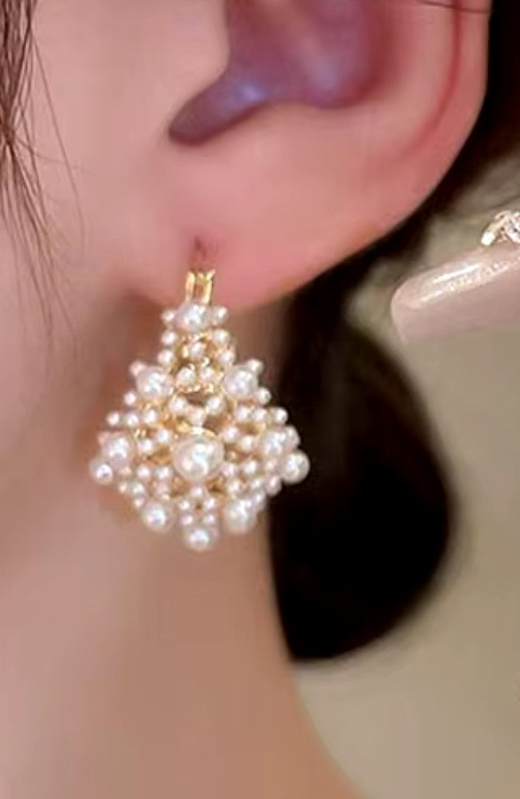 Woman wearing Alam Ara Timeless Pearl Earrings, U-shaped flower basket design, elegant daily wear