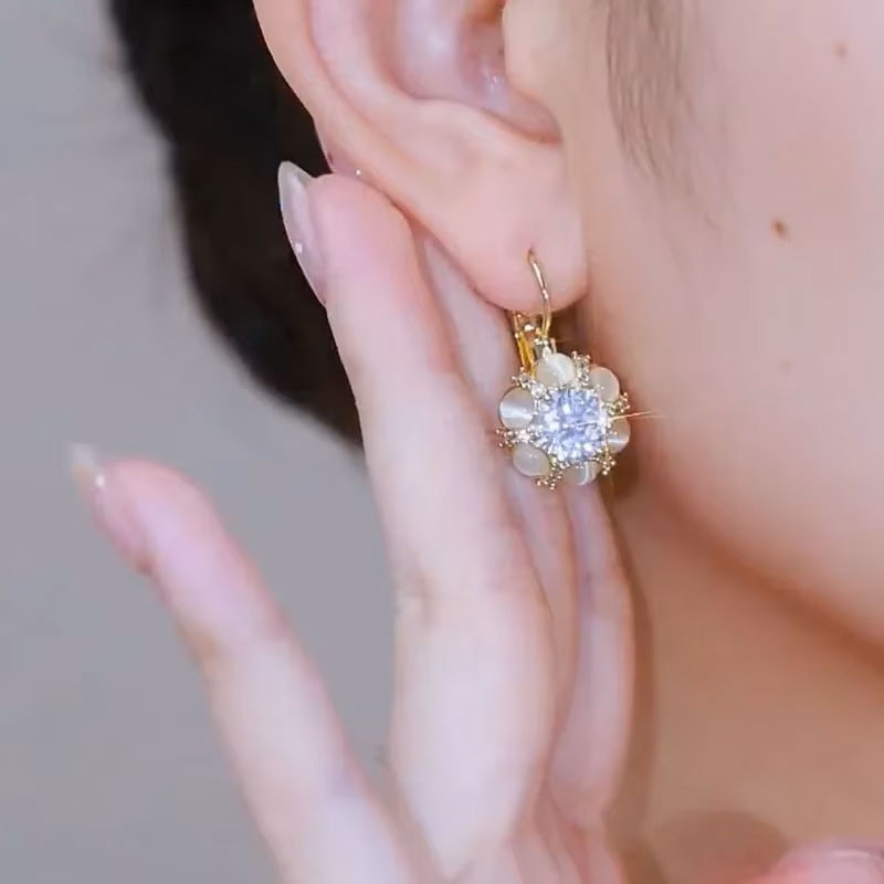 Woman wearing Alam Ara white opal earrings, showing elegant daily wear style in Pakistan